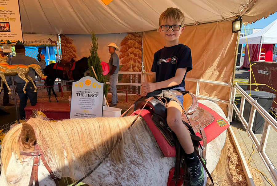 Our son riding on a pony at the fair